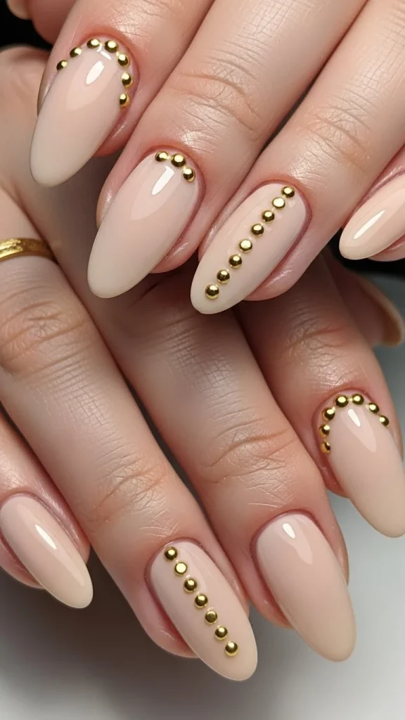 Soft Beige Nails with Gold Stud Accents